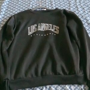 1 black and white Los Angeles sweater and 1 white pink hoodie